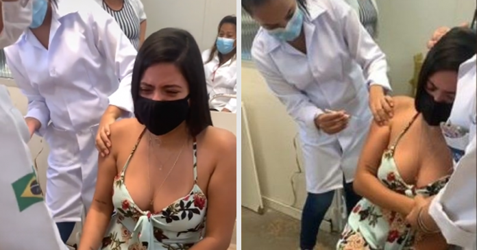 Jovem com medo de agulhas é abraçada por enfermeira ao receber vacina contra Covid
